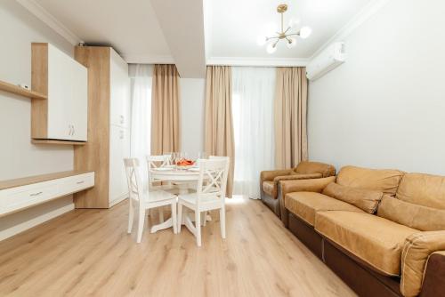 a living room with a couch and a table at City Walk Apartment & MiRent in Chişinău