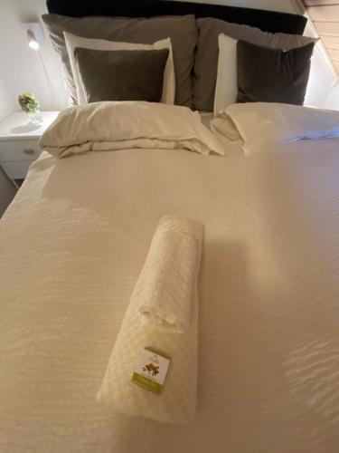 a white bed with a towel on top of it at Villa Thorse in Husvik