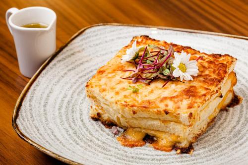 a white plate with a piece of food with flowers on it at Fairmont Rio de Janeiro Copacabana in Rio de Janeiro