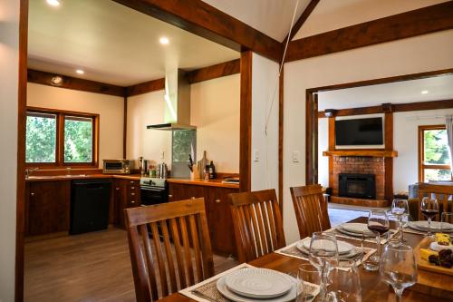 a kitchen and dining room with a table and chairs at Muirs Reef Lodge Kinloch holiday home Lake Taupo in Kinloch