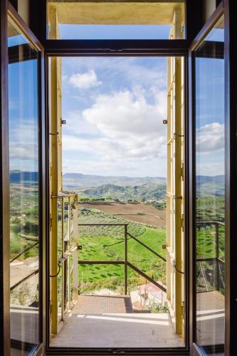 an open window with a view of a green field at Studio OF in Leonforte