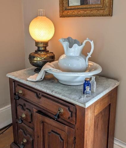 a table with a vase and a lamp on it at Historic Home with Southern Charm in Bristol