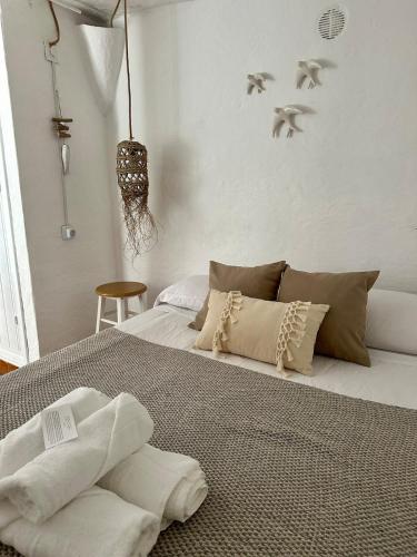 a bedroom with a bed with towels on it at Loft en Binibeca in Binibeca