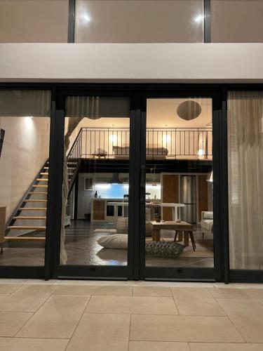 a living room with sliding glass doors and a staircase at Evas Urban loft 1 CLOSE TO PYTHAGOREIO in Chóra