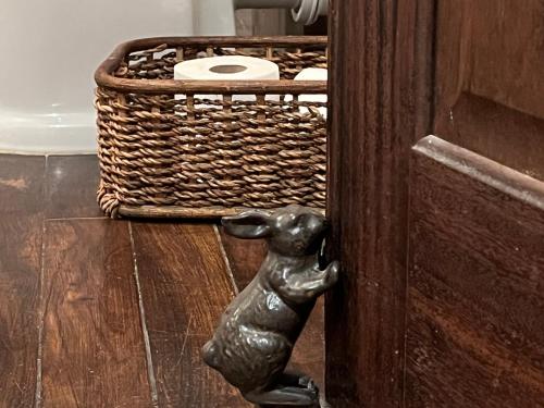 a statue of a dog knocking at a door at Park Farm in Windsor