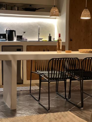 a kitchen with a white table with two chairs at Evas Urban loft 1 CLOSE TO PYTHAGOREIO in Chóra