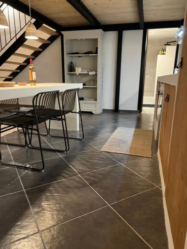 a kitchen with a table and chairs on a tile floor at Evas Urban loft 1 CLOSE TO PYTHAGOREIO in Chóra