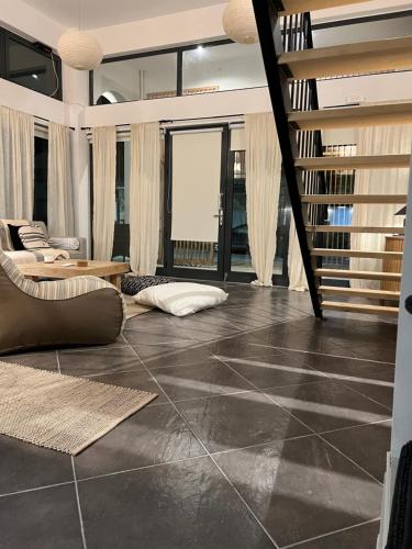 a living room with a tile floor and a staircase at Evas Urban loft 1 CLOSE TO PYTHAGOREIO in Chóra