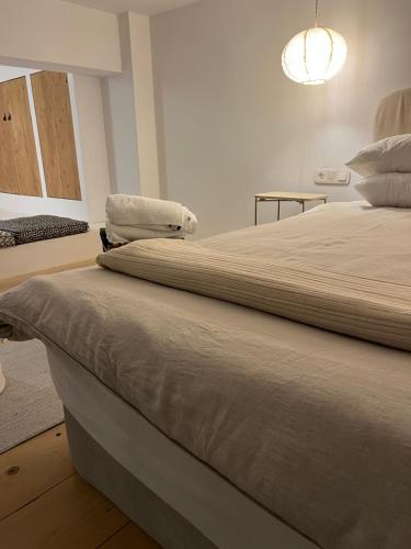 a large bed in a room with a light at Evas Urban loft 1 CLOSE TO PYTHAGOREIO in Chóra