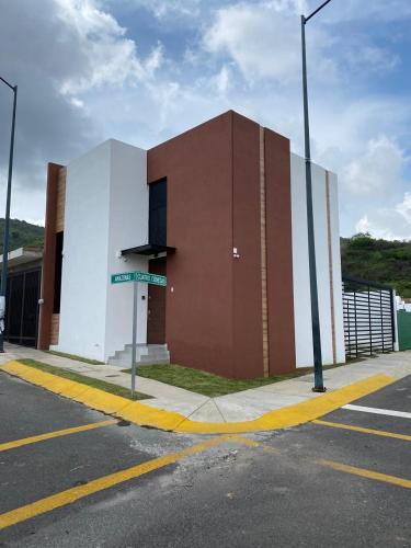 a brown and white building with a street sign in front at Casa Puerta Paraíso in Tepic