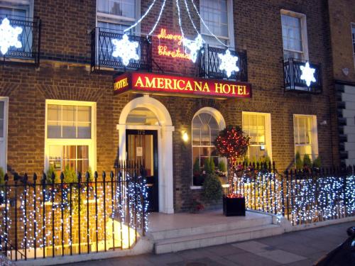 a americanana hotel with christmas lights in front of it at Americana Hotel in London