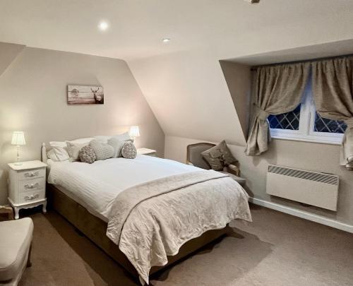 a bedroom with a large bed and a window at Park Farm in Windsor