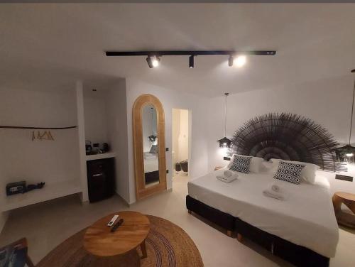 a bedroom with a large bed and a table at Gazelle Living in Imerovigli
