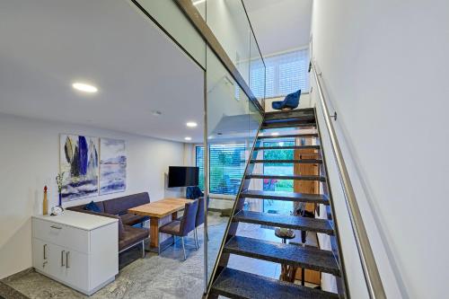 a staircase in a house with a desk and a table at STERK Apartments - idyllisch - modern - stilvoll in Meckenbeuren