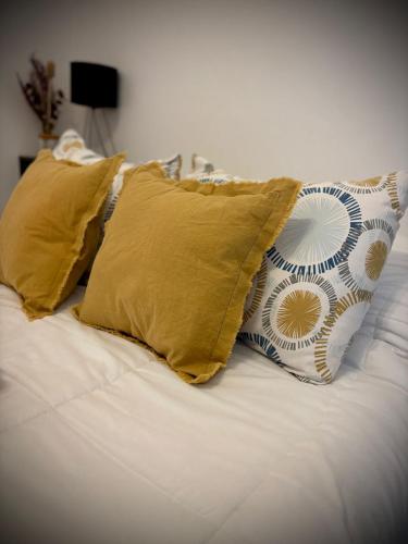 a white bed with two pillows on top of it at Alsina - Central Point Apartments in Salta