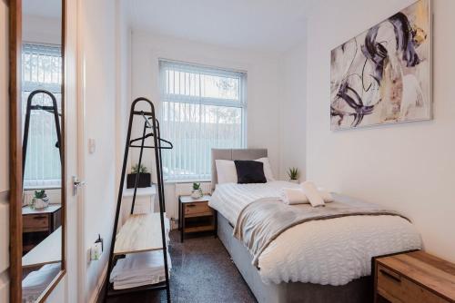 a bedroom with a bed and a ladder in it at Free parking, late check out CoOp Live Etihad Stadium 3-bed house in Manchester