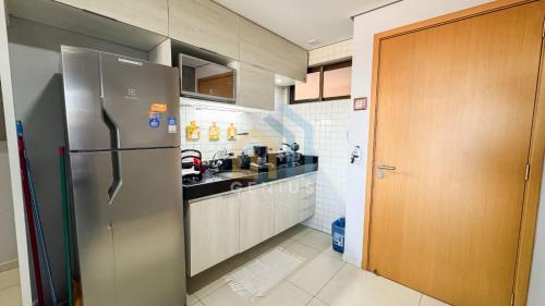 a kitchen with a stainless steel refrigerator and a counter at Eco Summer Tambaú WB Genius Flats in João Pessoa