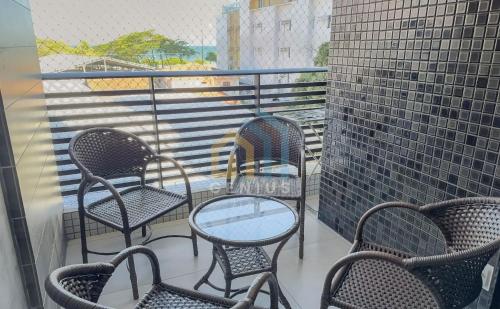a group of chairs and tables on a balcony at Eco Summer Tambaú WB Genius Flats in João Pessoa