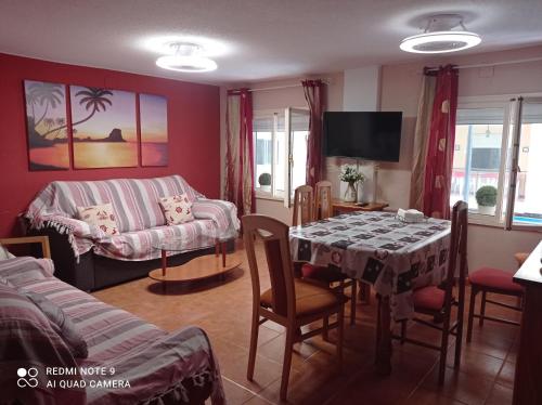 a living room with a table and a couch at Apartamento Cool en calpe!centro Turístico y playa in Calpe