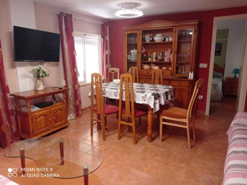 a dining room with a table and chairs at Apartamento Cool en calpe!centro Turístico y playa in Calpe
