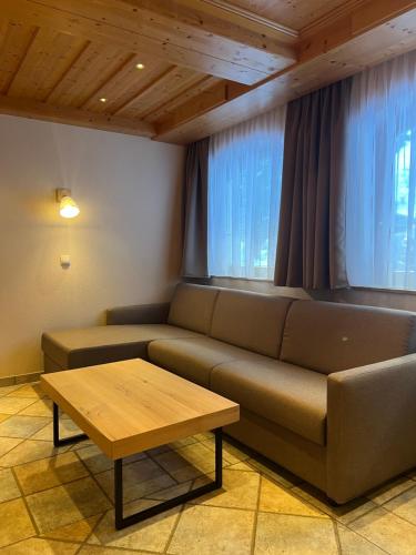 a living room with a couch and a table at apart STURPEN in Sankt Leonhard im Pitztal