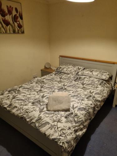 a bed in a bedroom with a blanket on it at JOE'S PLACE in Retford