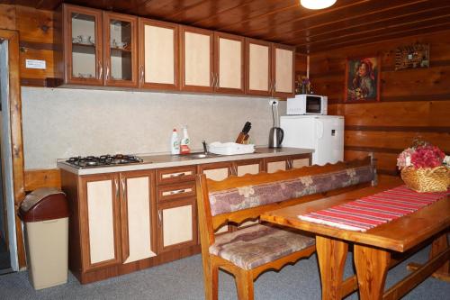 a kitchen with a counter and a table and a stove at Penzión Goraľka in Ždiar