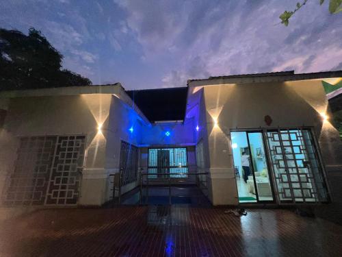 a house with blue lights on it at night at V Square Villa in Shenwa