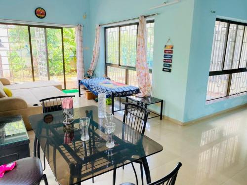 a living room with a glass table and chairs at V Square Villa in Shenwa