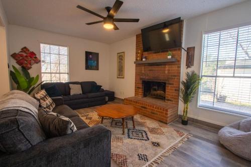 a living room with a couch and a fireplace at The Wonder Inn - Sleeps 11 near TCU in Fort Worth