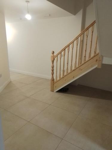a staircase in a room with a tile floor at St Anthony s in Midleton