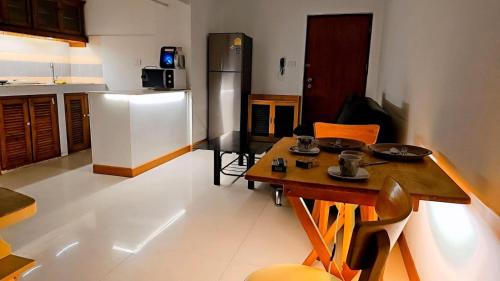 a kitchen with a wooden table and a refrigerator at River View Bangkok in Bangkok