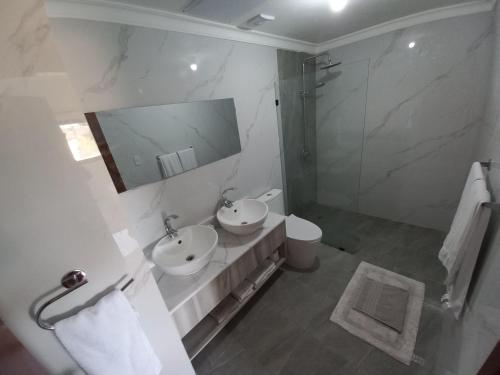 a bathroom with a sink and a shower and a mirror at New Spacious & Bright 2BR & 2BA, Pool & Beach Shuttle, WIFI & AC Gold Reef 209 in Punta Cana