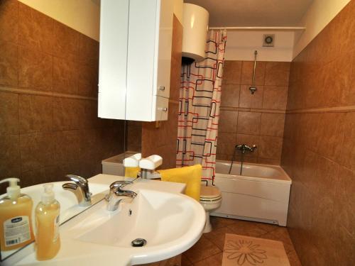 a bathroom with a sink and a toilet at Apartments Nikica in Seget Vranjica