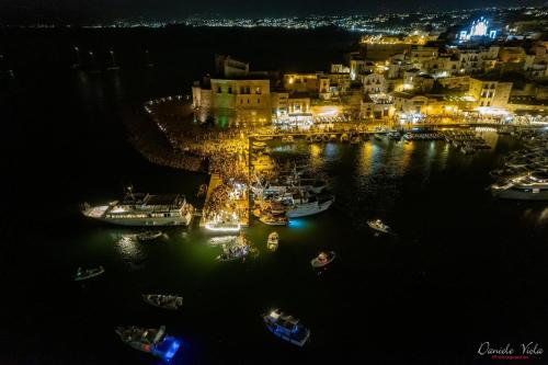 a group of boats in a harbor at night at Ciuri Ciuri in Castellammare del Golfo