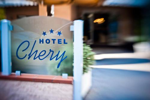 a sign for a hotel cheney sitting on a fence at Hotel Chery in Milano Marittima