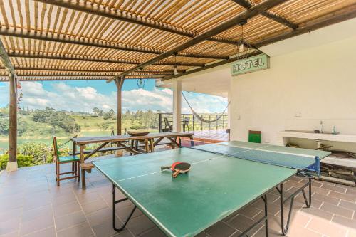 a ping pong table in a room with a view at La Villa, Espectaculares vistas al lago Peñol-Guatape in Guatapé