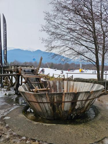 a wooden boat sitting on the ground next to a snow covered field at Private Suite at Comfort Bansko in Bansko