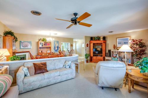 a large living room with a couch and a kitchen at Spacious Home with Yard - half Mi to Ormond Beach! in Ormond Beach