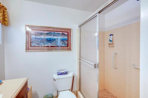 a bathroom with a white toilet and a shower at Spacious Home with Yard - half Mi to Ormond Beach! in Ormond Beach