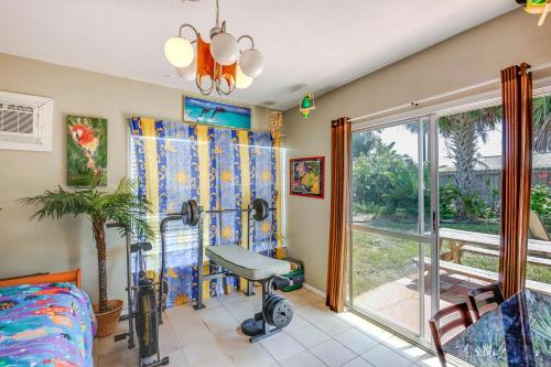 a childrens room with a wheelchair in front of a sliding glass door at Spacious Home with Yard - half Mi to Ormond Beach! in Ormond Beach