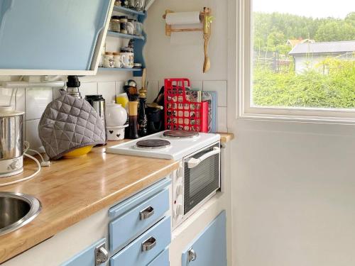 a kitchen counter with a stove and a window at 4 person holiday home in KOLMÅRDEN-By Traum in Kolmården
