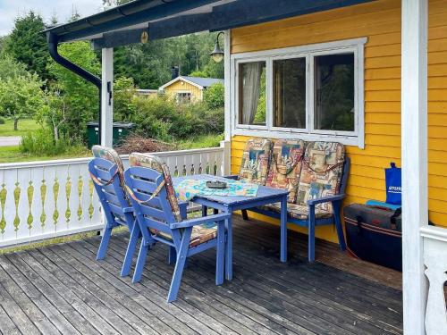 a table and chairs on the porch of a house at 4 person holiday home in KOLMÅRDEN-By Traum in Kolmården