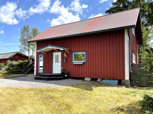a red barn with a white door and a window at 4 person holiday home in GAMLEBY-By Traum in Gamleby