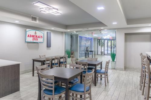 a restaurant with tables and chairs and a sign that reads animals inn at Admiral's Inn on Tybee Island in Tybee Island
