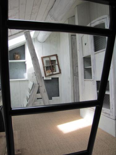 a view through a window of a room with windows at Gite De Charme Auvergne Cab'âne in Brousse