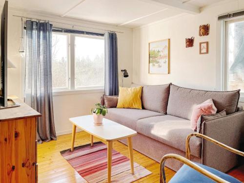 a living room with a couch and a table at 4 person holiday home in HERRäNG-By Traum in Herräng