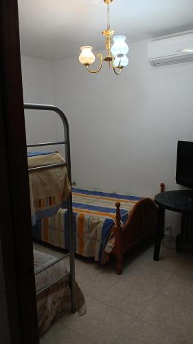 a bedroom with a bunk bed and a chandelier at Habitacion Privada Triple Toledo in Toledo