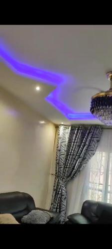 a room with a curtain and a room with chairs at Familly fun in Dakar