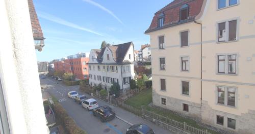 a view of a city street with buildings and cars at 2-4 Zimmer Apartments Stilvoll im Gertrud Schlössli - zentral ruhig in St. Gallen